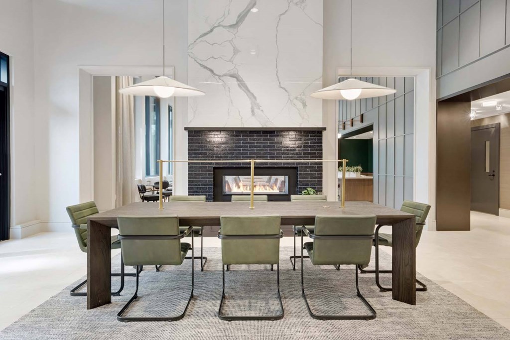 A modern dining room with a large table and chairs.