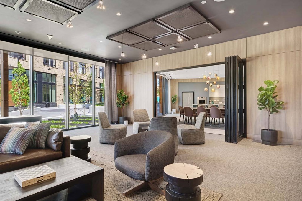 A modern living room with a large window and a view of the city.