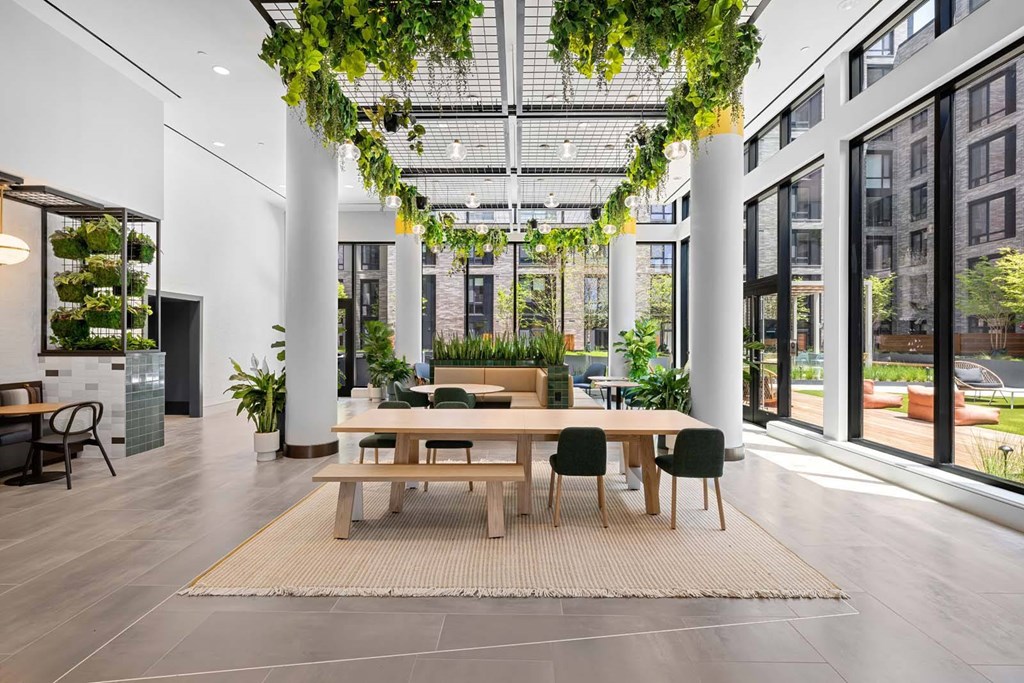 A modern dining area with a long table and chairs.