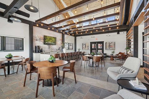 A modern dining room with wooden furniture and a stone floor.