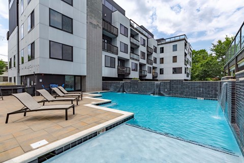 A swimming pool in front of apartment buildings.