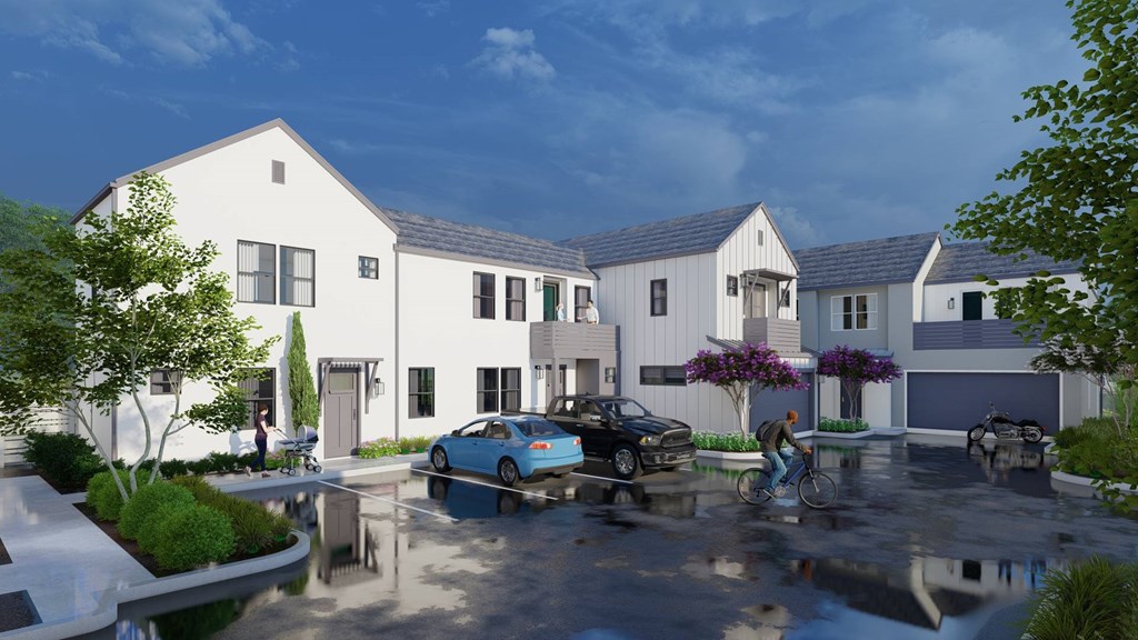 A white house with a black car parked in front.