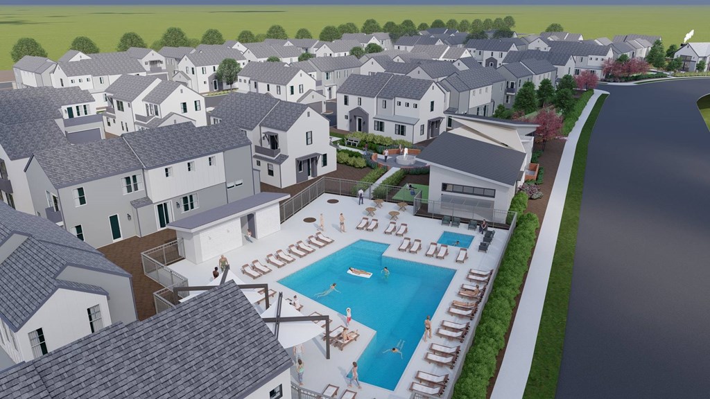 A pool surrounded by lounge chairs is in the foreground of a residential area.