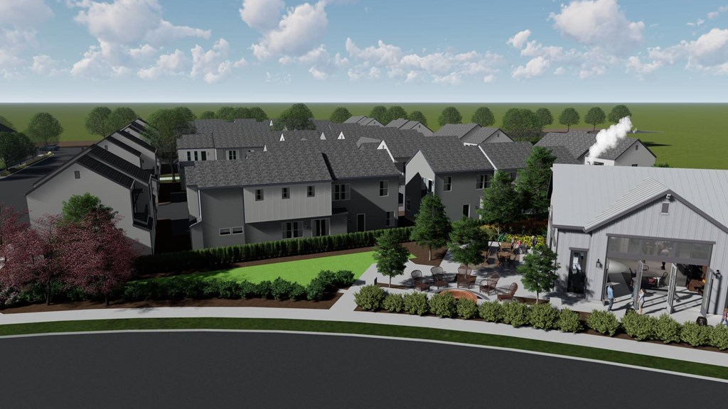 A row of houses with a road in front of them.