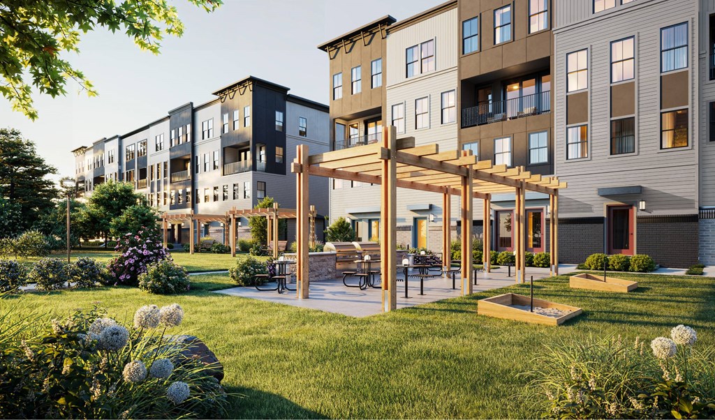 A modern apartment complex with a communal garden area.