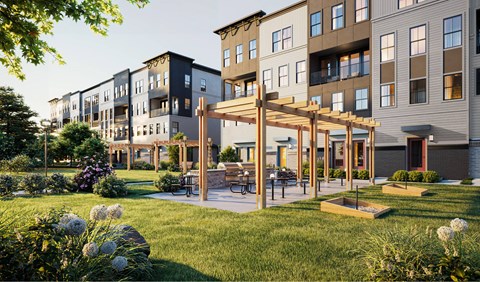 A modern apartment complex with a communal garden area.