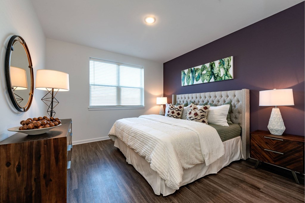Spacious bedroom with bright windows and plank flooring at Brandywine Green, Brandywine, 20613