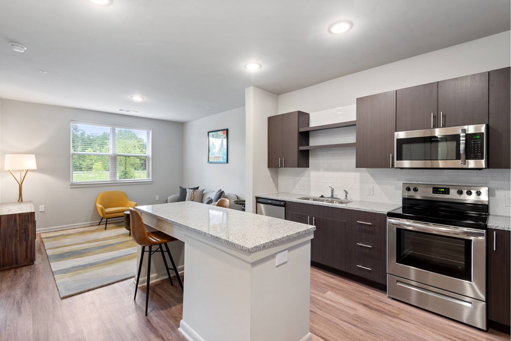 Well-appointed kitchen with granite countertops, island and stainless steel appliances at Brandywine Green, Brandywine, MD, 20613