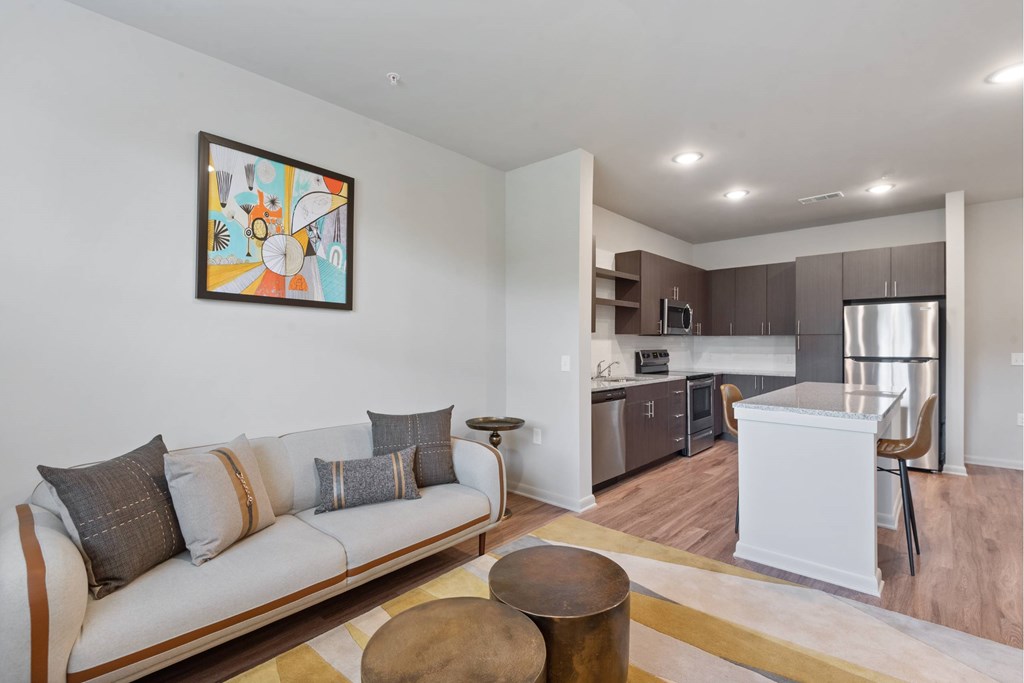 Open living room and kitchen with plank flooring throughout at Brandywine Green, Brandywine, Maryland