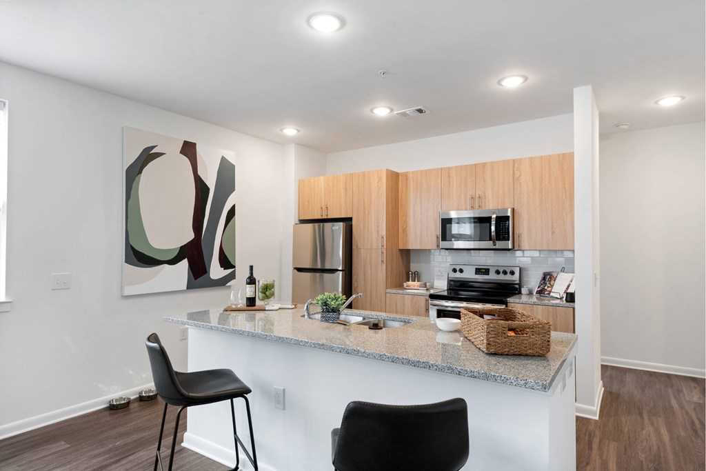 Well-appointed kitchen with island and granite countertops at Brandywine Green, Brandywine, MD, 20613