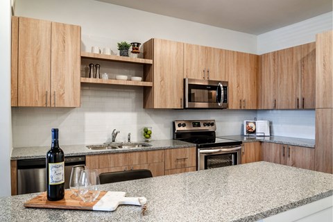 A kitchen with wooden cabinets and a granite countertop.