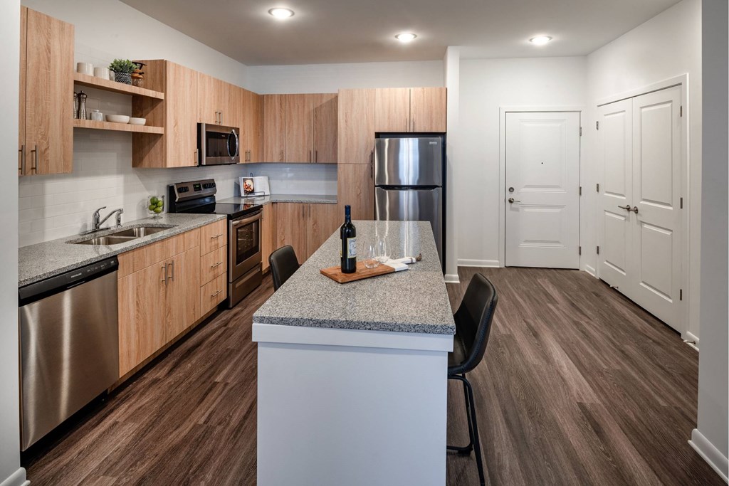 A  modern kitchen with wooden cabinets and granite countertops at Brandywine Green, Maryland