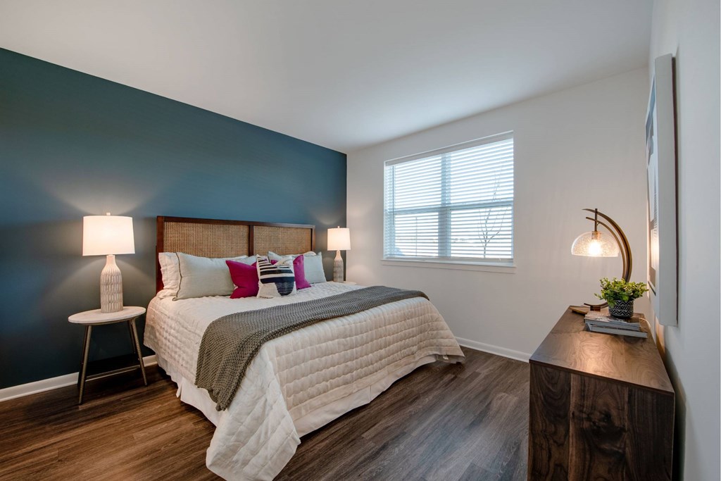 Spacious bedroom with bright windows and plank flooring at Brandywine Green, Brandywine, 20613