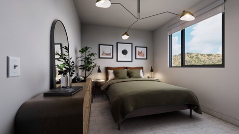 A bedroom with a large bed and a view of the outdoors through a window.