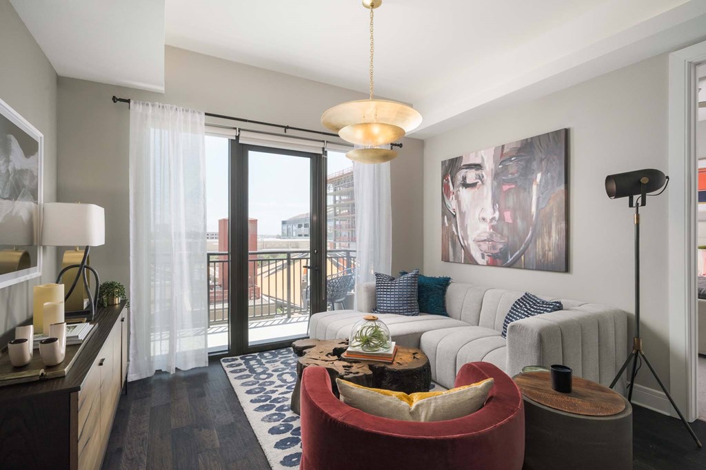 A modern living room with a red armchair and a white sofa.