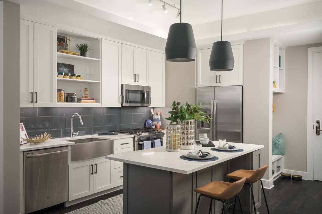 A modern kitchen with a dining table and chairs.