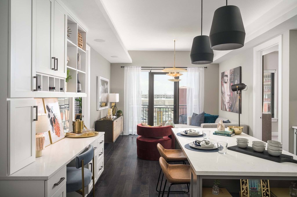 A modern kitchen with white cabinets and a large island.