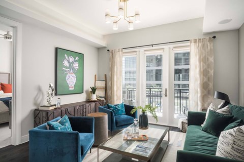 A living room with a blue sofa and a green couch.