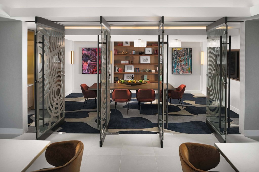 A modern room with a glass partition and a white table.
