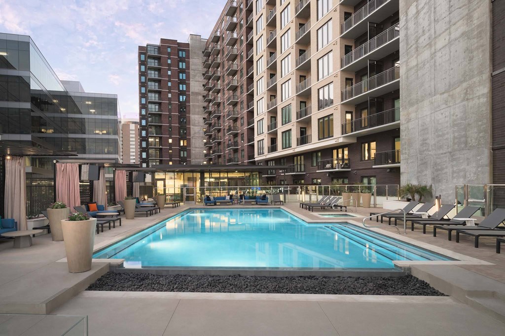 A large swimming pool in the middle of a courtyard surrounded by buildings.
