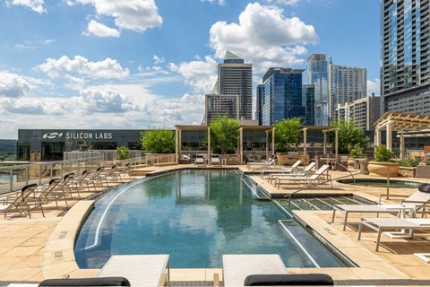 A pool area with chairs and a sign that says Silicon Labs.
