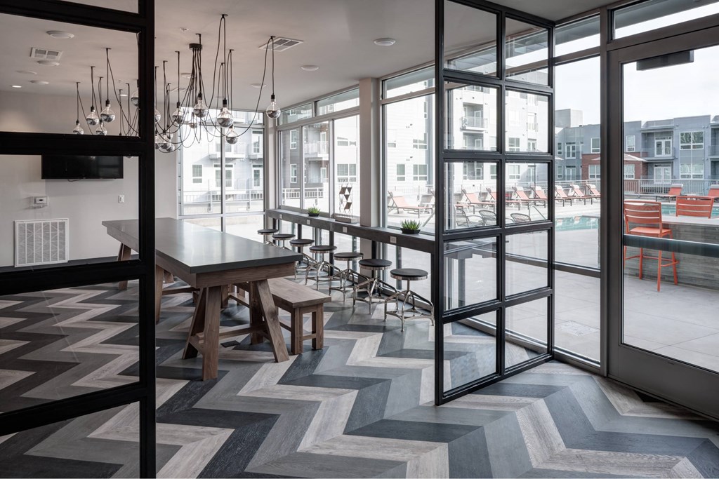 A modern kitchen with a dining table and chairs.