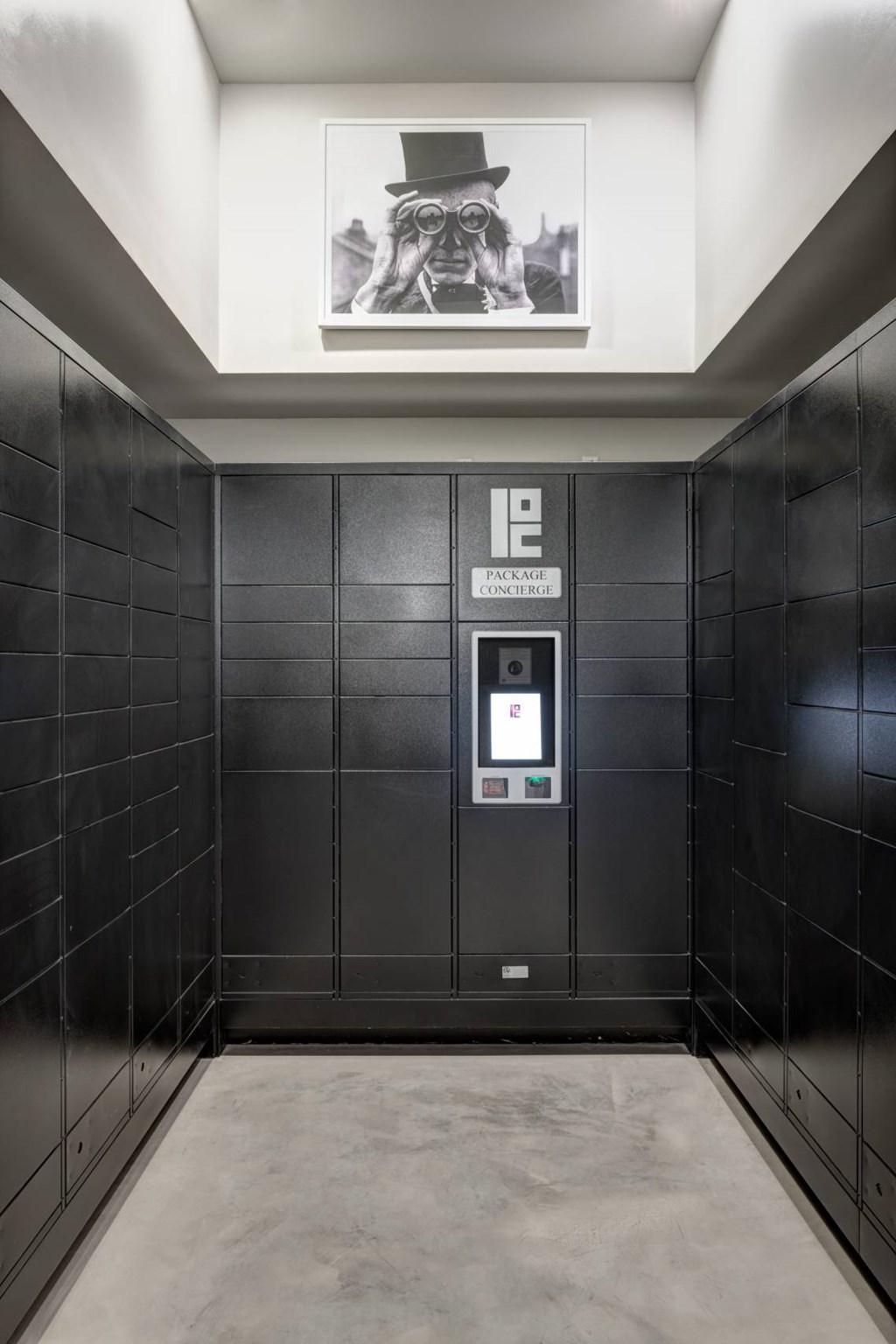 A black elevator with a picture of a man in a top hat hanging from the ceiling.