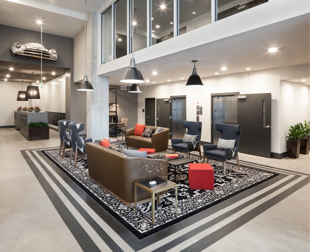 A modern living room with a striped rug and a variety of seating options.