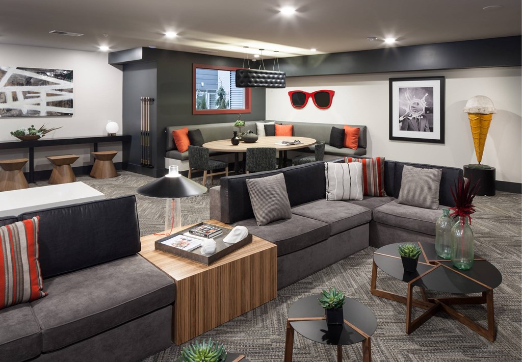 A modern living room with grey sofas and a wooden coffee table.