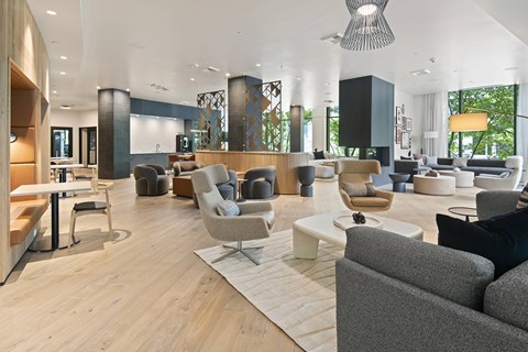 A modern living room with a grey sofa and a wooden floor.