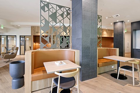 A modern dining area with a wooden table and chairs.