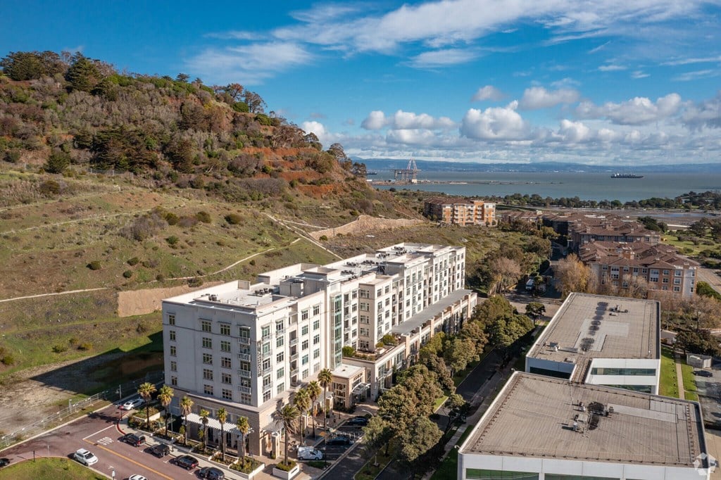 A large white building with a parking lot in front of it.