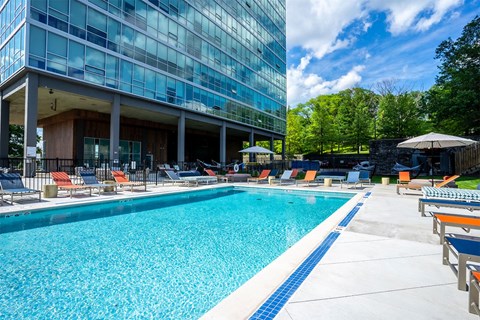 A large swimming pool in front of a modern building.