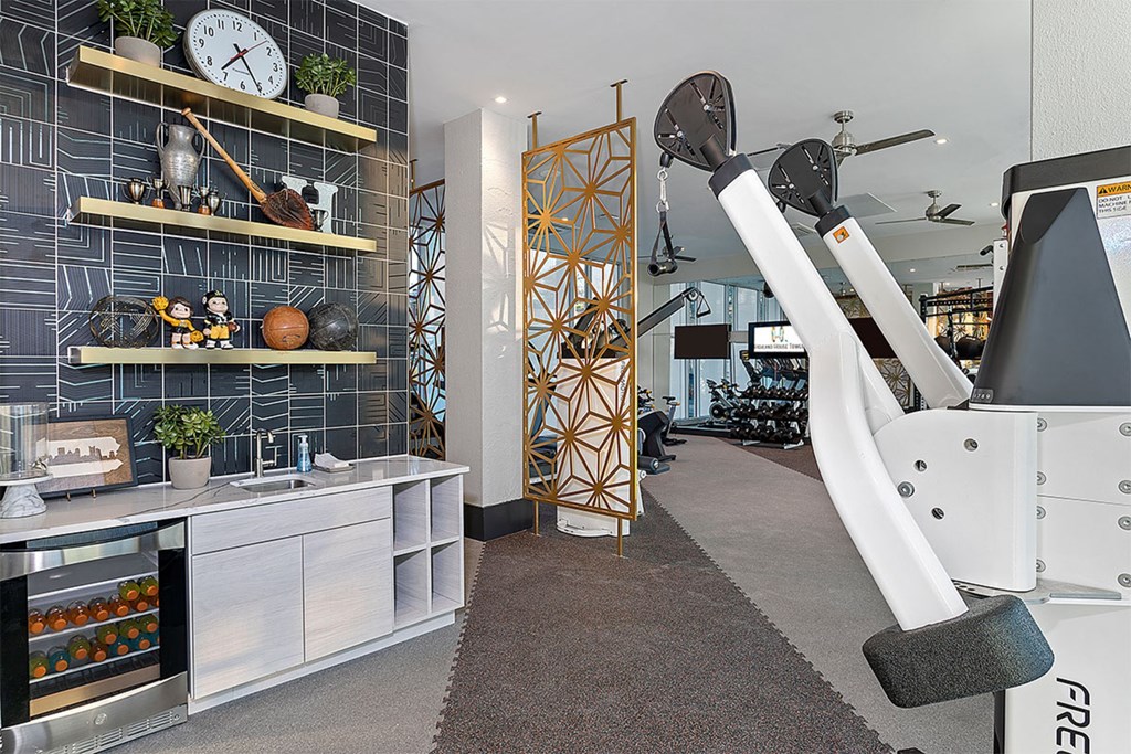 A gym with a treadmill and weights.