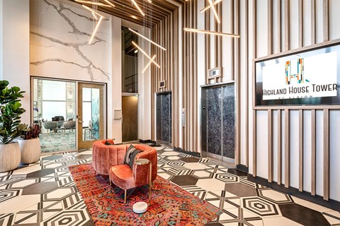 A modern living room with a red sofa and a patterned rug.
