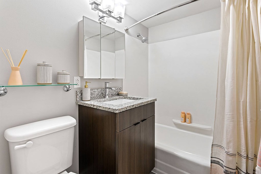 A white bathtub sits next to a sink in a bathroom.