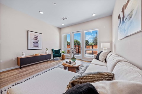 A living room with a white couch and a coffee table.