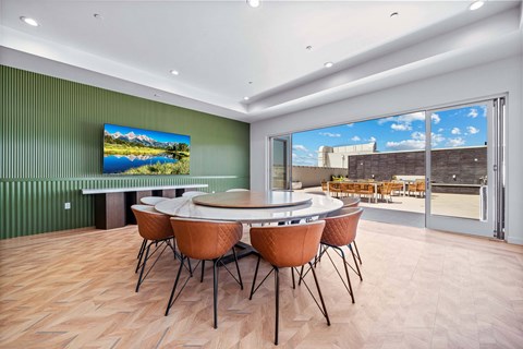 A conference room with a large table and chairs.