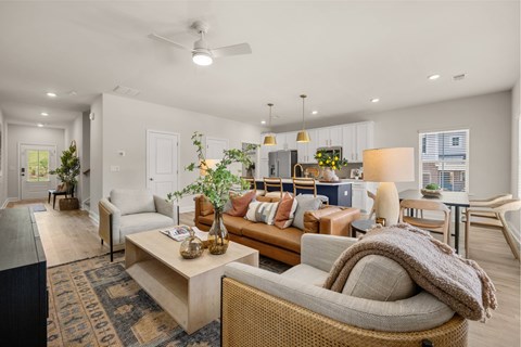 A living room with a grey couch and a wooden coffee table.