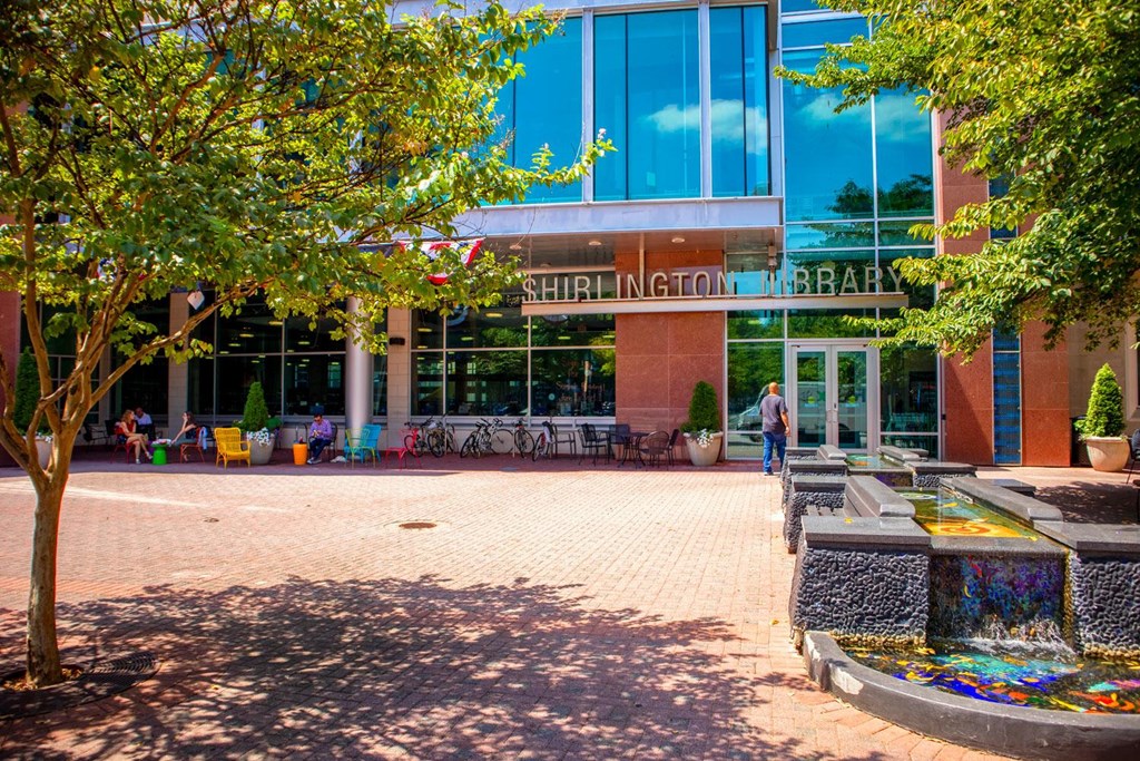 A library entrance with a fountain in front.