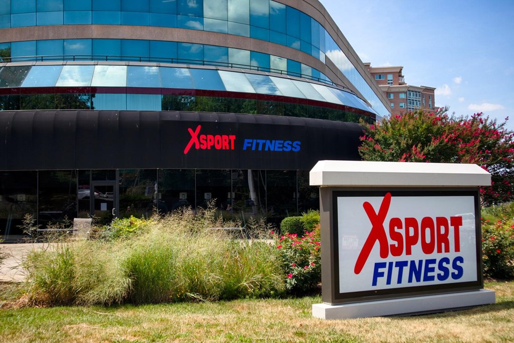 A fitness center with a sign that says XSport Fitness.