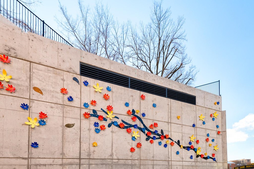 A wall with a bunch of paper flowers on it.