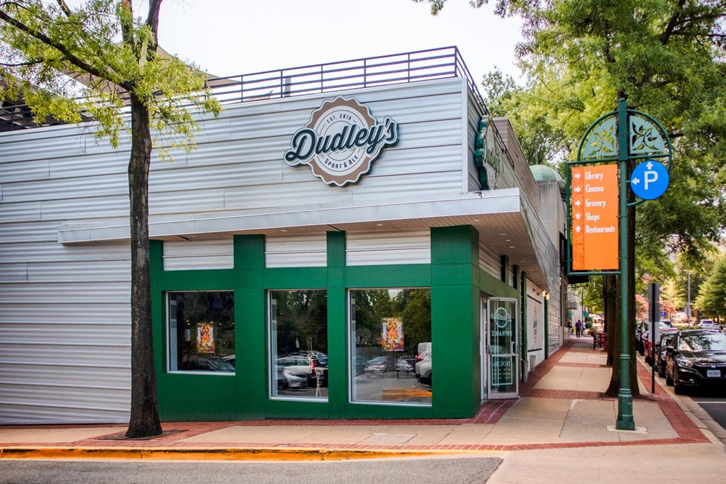 A storefront with a green awning and a sign that says Dudley's.