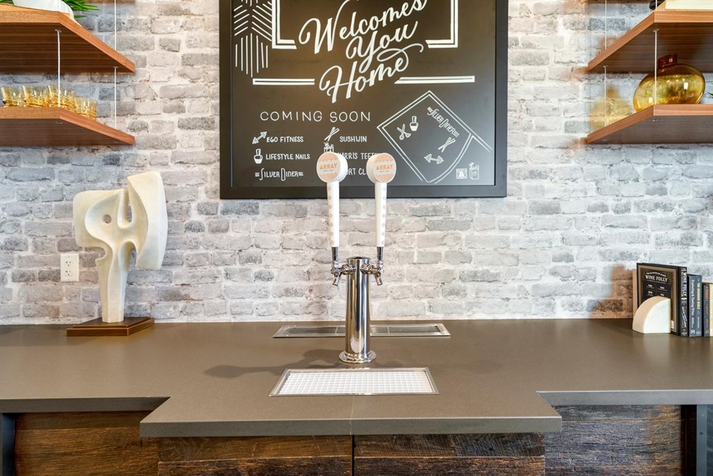 A chalkboard sign welcomes people to a home with a list of amenities.