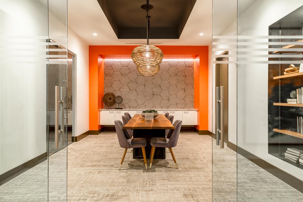 A modern dining room with a wooden table and chairs.
