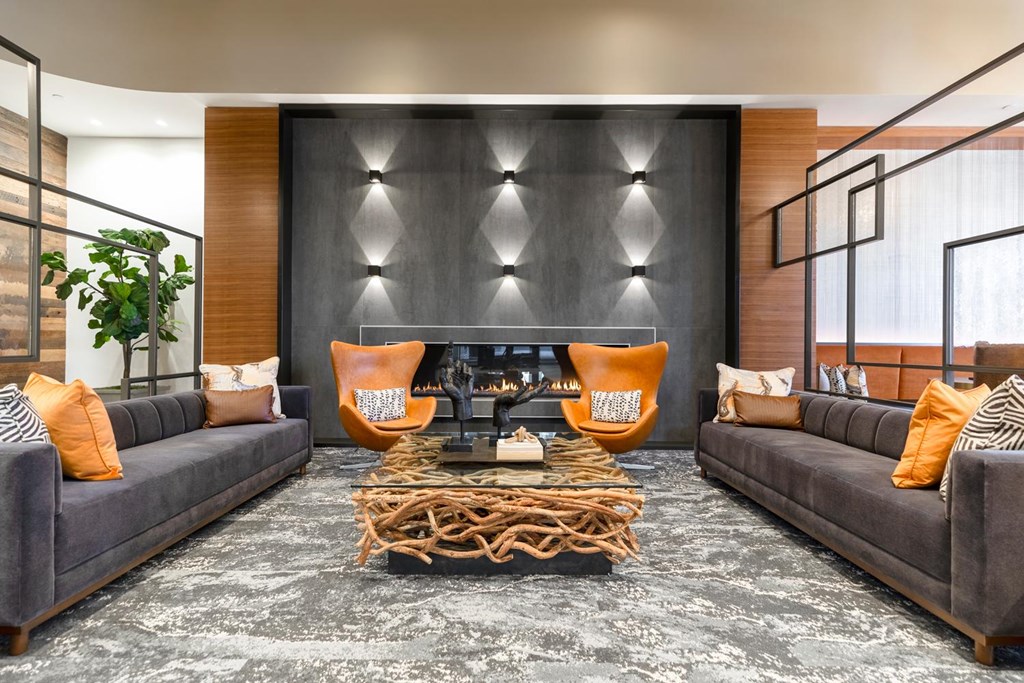 A modern living room with grey sofas and a wooden coffee table.
