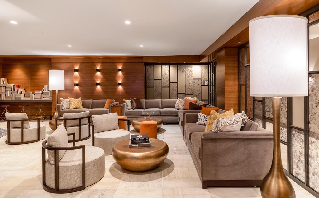 A modern living room with a large sofa, armchairs, and a coffee table.