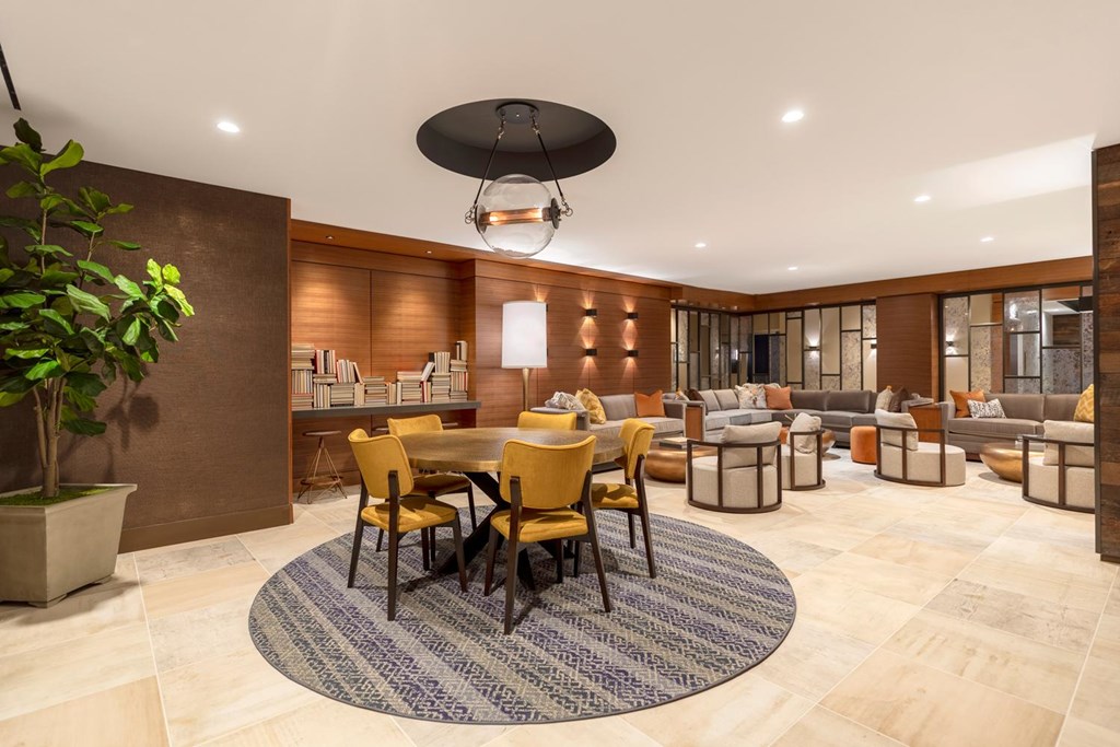 A modern dining room with a round table and chairs.