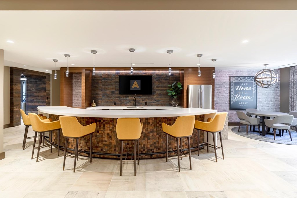 A modern dining room with a long table and chairs.