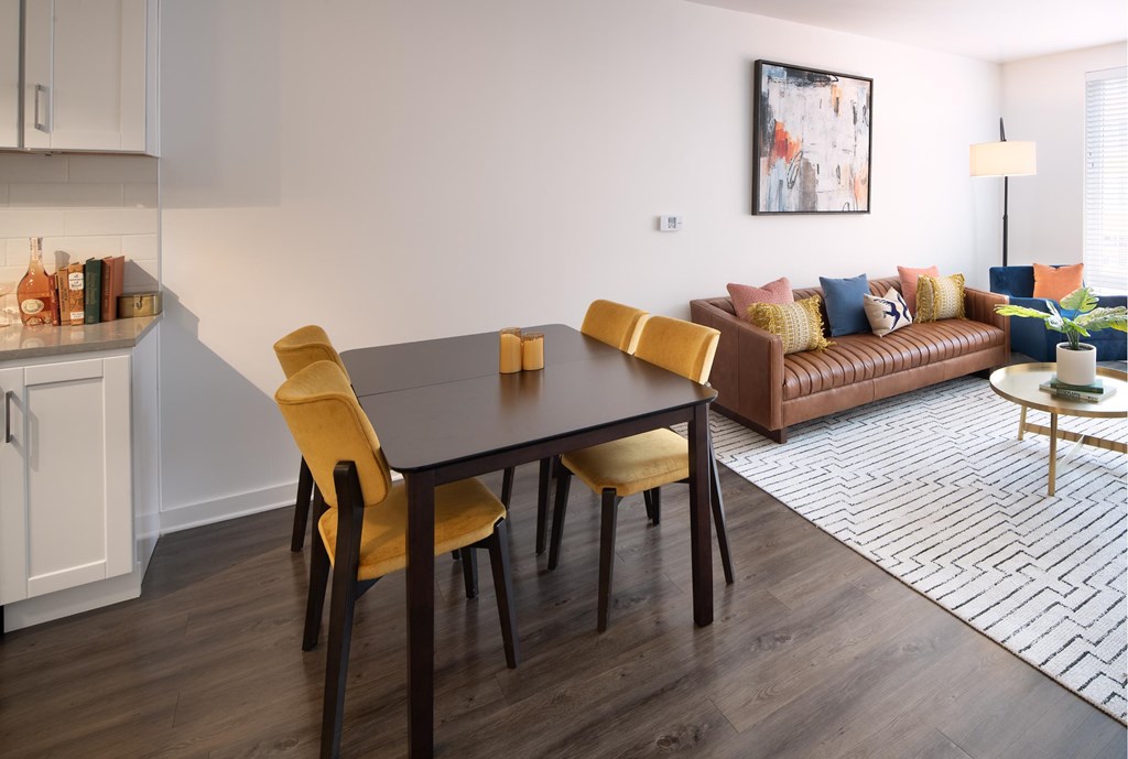 A modern dining room with a wooden table and chairs.